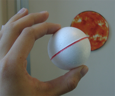 hand holding small white ball
